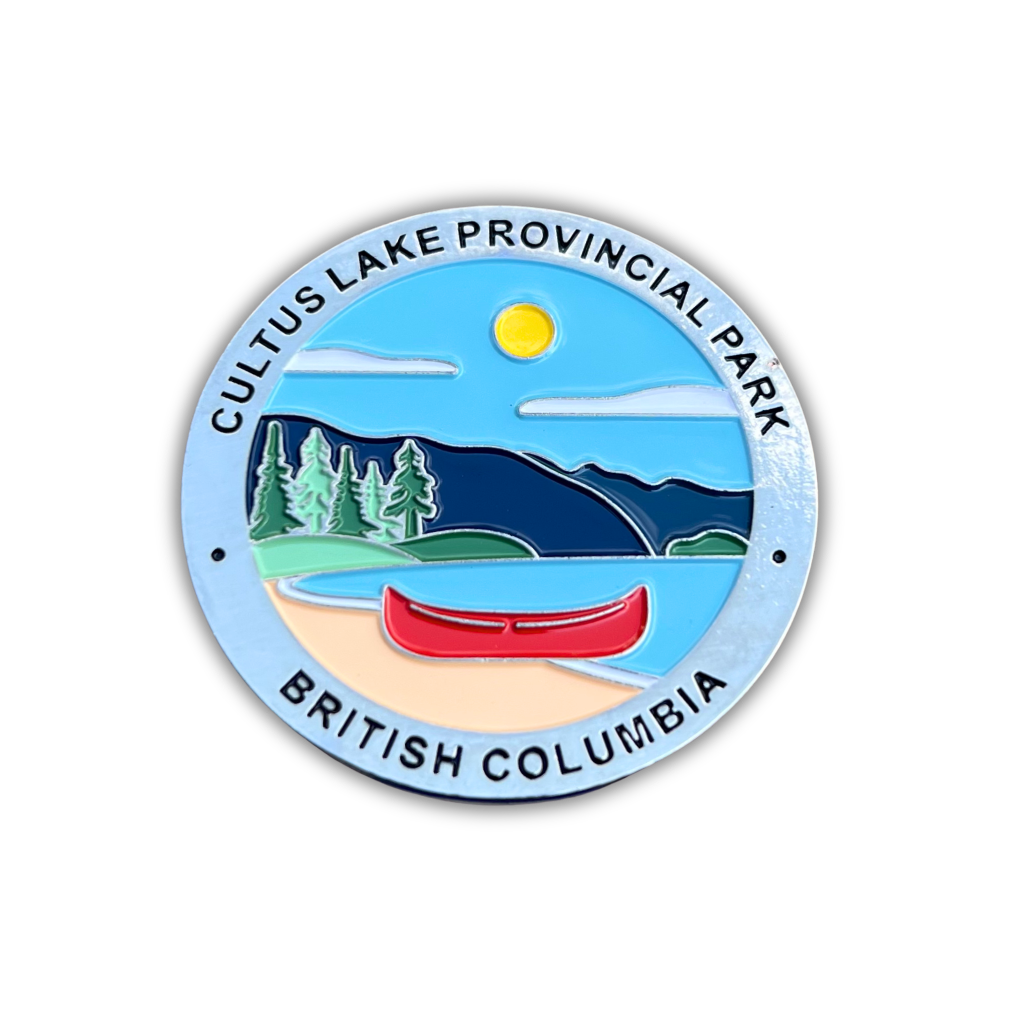 A circular enamel-style park magnet for Cultus Lake Provincial Park in British Columbia, featuring a blue lake, red canoe, green trees, dark blue mountains, and a yellow sun, with the park name and province printed around the border.