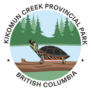 Logo of Kikomun Creek Provincial Park in British Columbia featuring a turtle on a log with trees in the background.