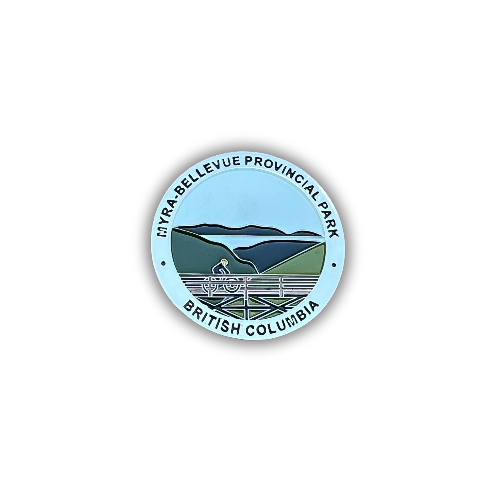 A circular sticker or badge featuring a stylized landscape of Myra-Bellevue Provincial Park in British Columbia, with a cyclist on a road running through green hills and blue mountains under a light blue sky. The text 'MYRA-BELLEVUE PROVINCIAL PARK' and 'BRITISH COLUMBIA' is printed around the border.