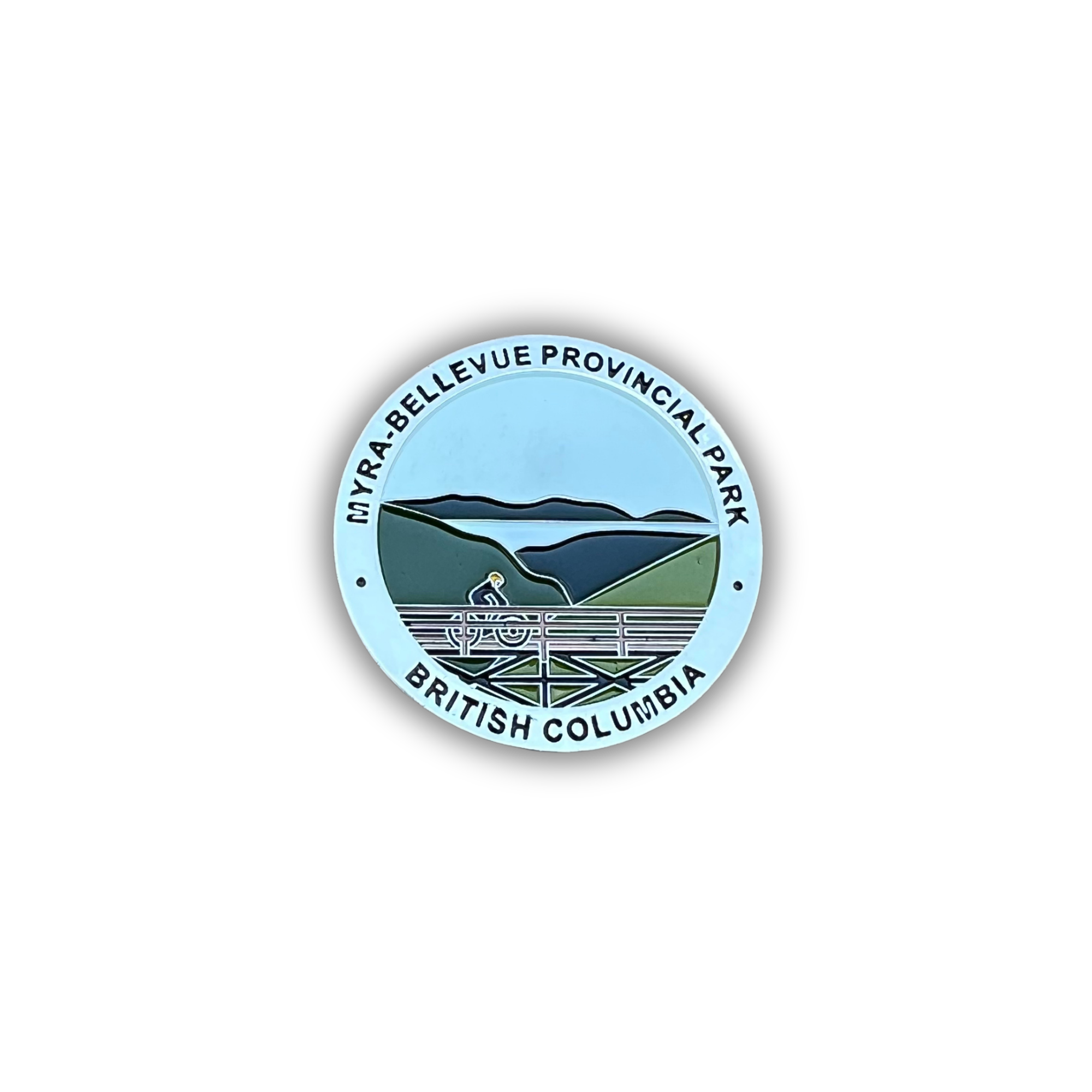 A circular sticker or badge featuring a stylized landscape of Myra-Bellevue Provincial Park in British Columbia, with a cyclist on a road running through green hills and blue mountains under a light blue sky. The text 'MYRA-BELLEVUE PROVINCIAL PARK' and 'BRITISH COLUMBIA' is printed around the border.