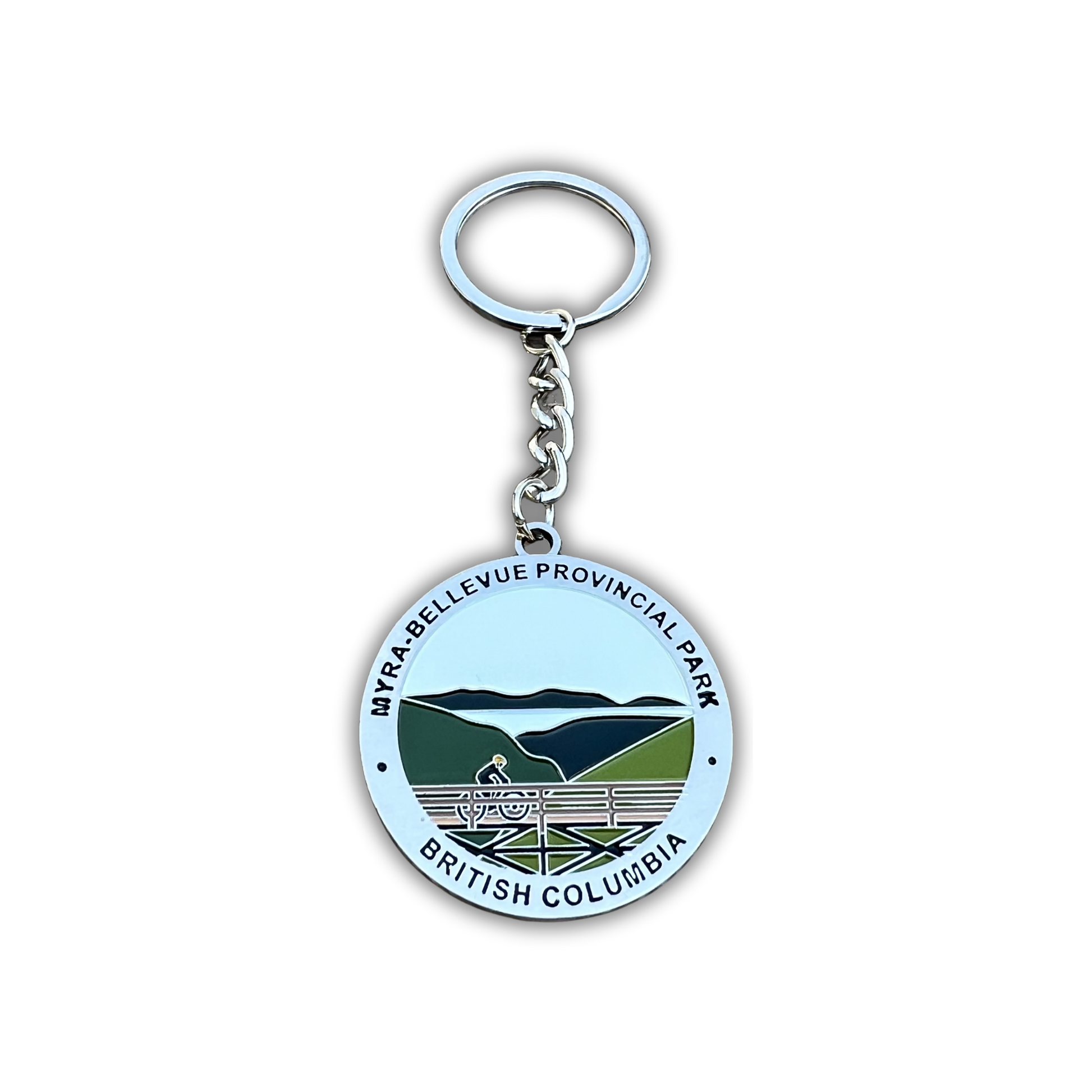 A round metal keychain featuring the Myra-Bellevue Provincial Park emblem from British Columbia, Canada. The silver-tone keychain has a circular pendant with a light blue background, green and dark blue mountain illustration, and black text reading 'MYRA-BELLEVue PROVINCIAL PARK' and 'BRITISH COLUMBIA'.