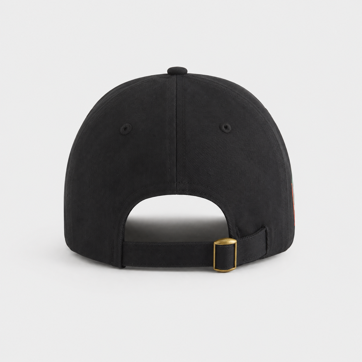 The back view of a black baseball cap with an adjustable strap and a gold-tone metal buckle, shown on a light gray background.